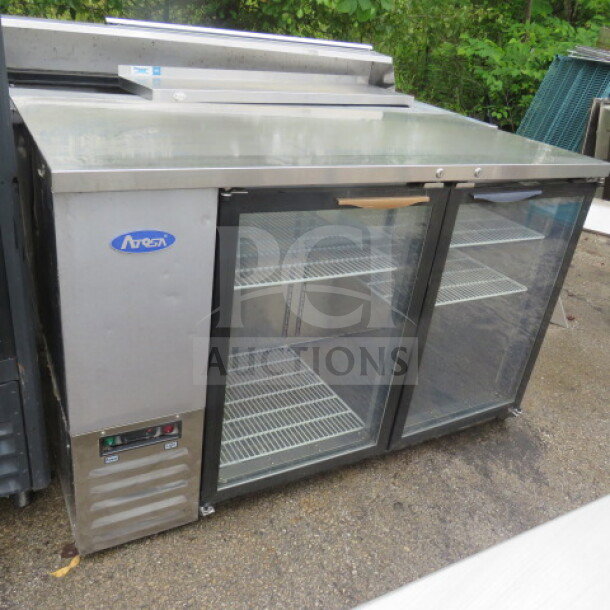 Atosa 2-door back bar glass display cooler, model MBB59GGR, with 4 racks, in working condition. Measures 57.5x27x37 inches.