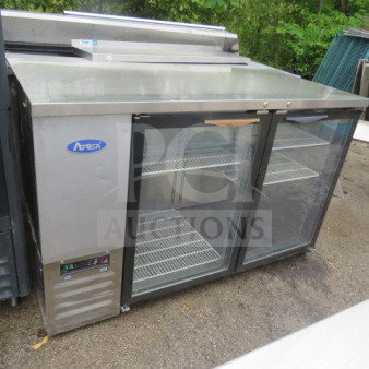 Atosa 2-door back bar glass display cooler, model MBB59GGR, with 4 racks, in working condition. Measures 57.5x27x37 inches.