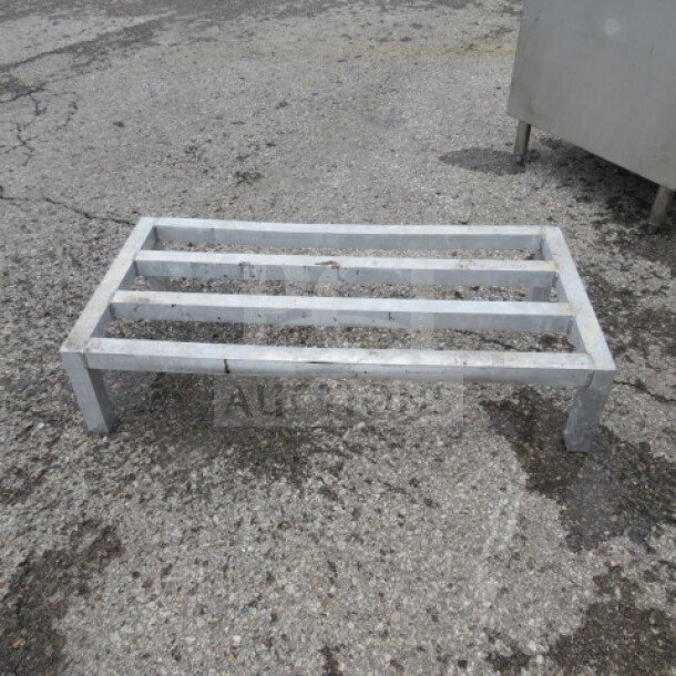 36x18x8 aluminum dunnage rack, used condition. Four legs, slatted top for storage. Ideal for elevating items in storage areas.