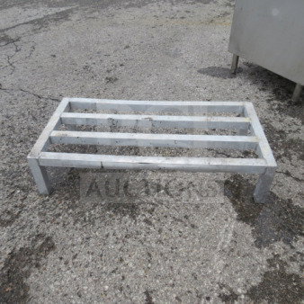 36x18x8 aluminum dunnage rack, used condition. Four legs, slatted top for storage. Ideal for elevating items in storage areas.