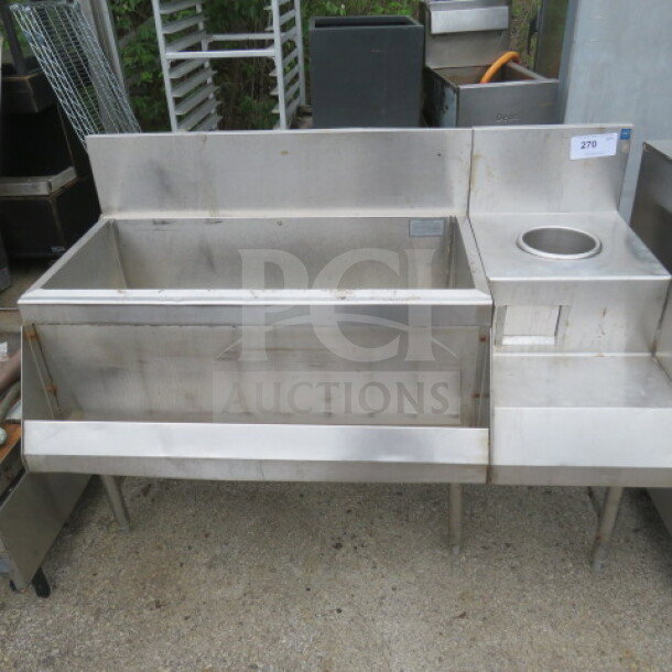 Stainless steel ice well with speed rail and blender shelf, dimensions 50x25x38 inches. Good condition.
