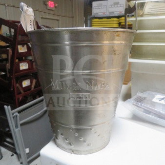 Stainless steel wine bucket with "Mumm Napa" engraving, textured base, used condition, suitable for wine chilling.