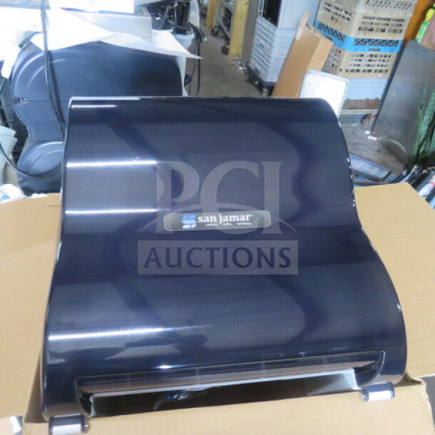 San Jamar T7100TBK wall mount paper towel dispenser, new condition, glossy black finish, logo label visible.