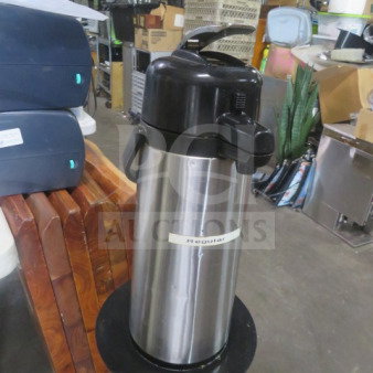 Stainless steel airpot with black lid and spout, labeled "Regular." Good condition, for hot beverages.