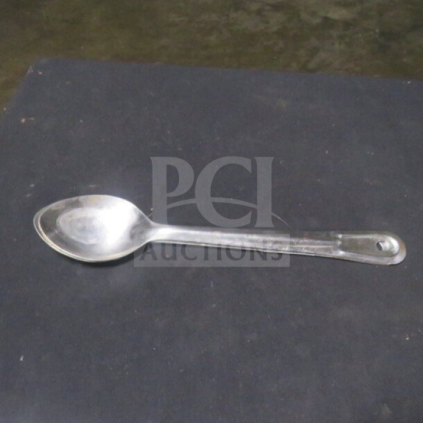 Stainless steel spoon, model 2XBID, in good condition. Simple design with a hole in the handle for hanging.