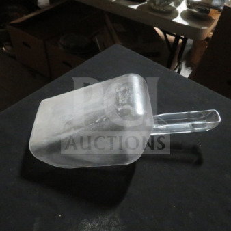 Clear poly scoop with a long handle, gently used, no visible markings or labels, suitable for versatile use.