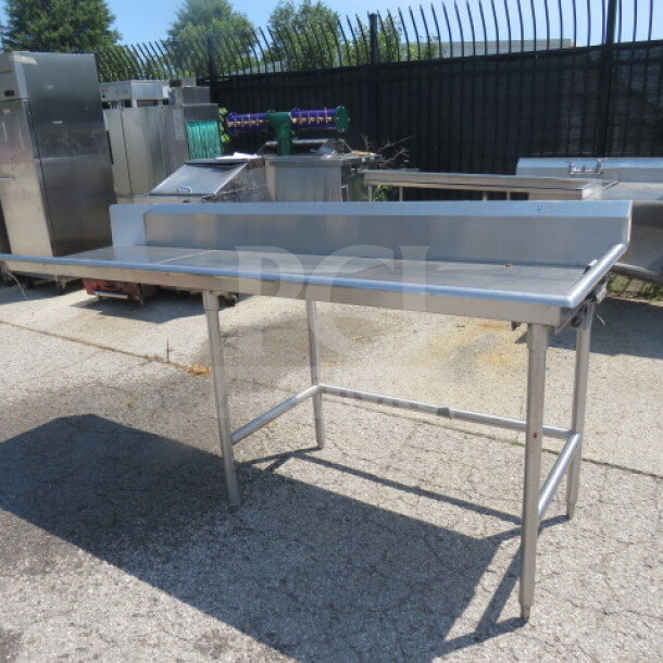 Stainless steel dishwasher table, one clean side, 90"x29"x37.5", sturdy frame, used condition, suitable for commercial kitchens.