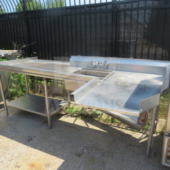 Stainless steel dishwasher table with under shelf, sink, and drain basket. Dimensions: 104"x49"x40". Good condition.