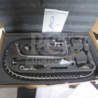 New sink faucet with hose sprayer, unboxed. Includes installation instructions. Chrome finish, modern design.