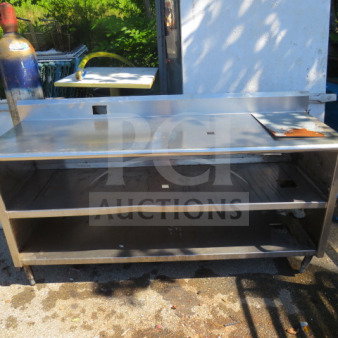 Stainless steel table with backsplash, two under shelves, size 72x24x39.5 inches. Features durable construction and ample storage.