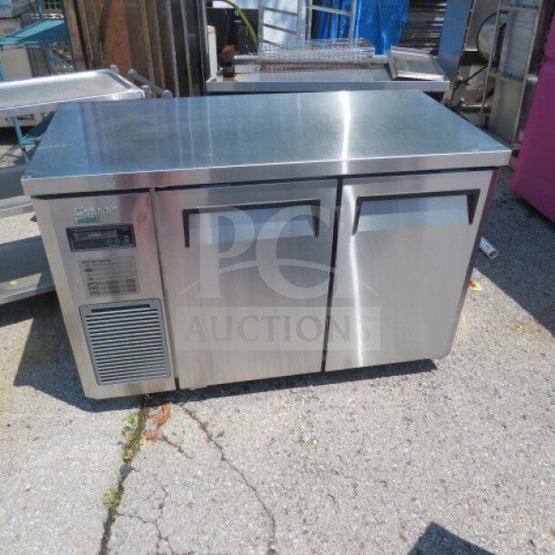 Turbo Air JUF-48D-N stainless steel 2-door worktop freezer, 48x24x32 inches, on casters, includes 1 rack, 115V, good condition.
