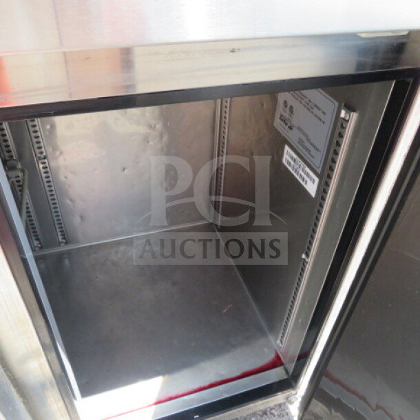 Turbo Air JUF-48D-N 2-door worktop freezer, 48x24x32 inches, on casters, stainless steel, visible interior rack space.