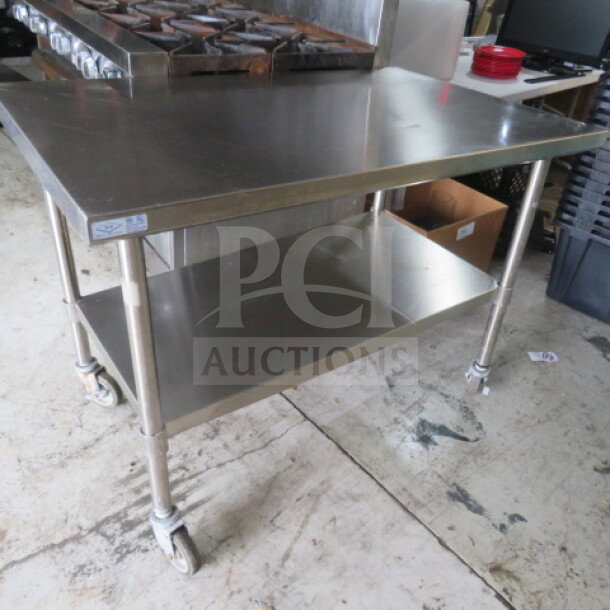 Stainless steel table with undershelf, 48x30x35.5 inches, on casters. Good condition, One Select brand.