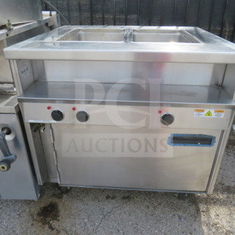 Randell 2 Well Steam Table with 1 Door Warmer, Model 31330, on casters. Stainless steel, used, 36x34x34.5 inches, 208V.