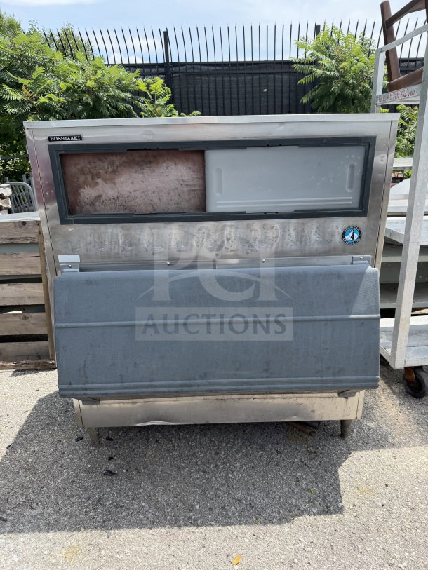 Hoshizaki ice bin, 48x39x54 inches. Stainless steel exterior, visible wear. Hoshizaki logo on top left corner.