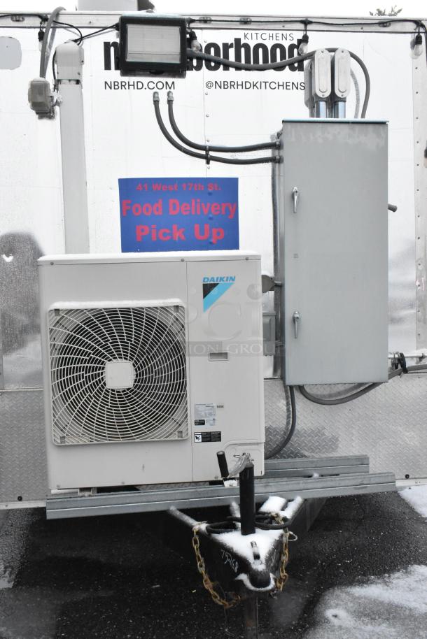 Cruising Kitchens 24' food trailer with Daikin unit, "Food Delivery Pick Up" sign, and utility connections.