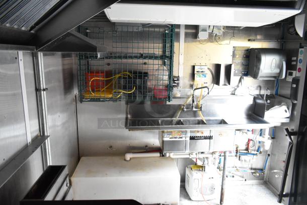 Cruising Kitchens 24' food trailer with commercial-grade equipment, stainless steel sink area, and storage racks, new in 2019.