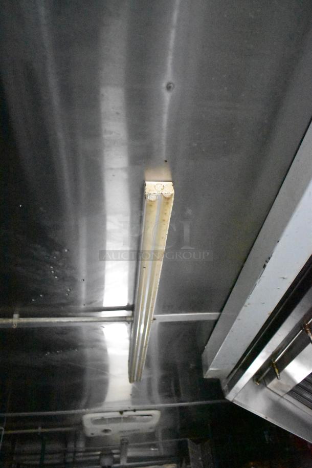 Ceiling view of Cruising Kitchens 24' food trailer, featuring overhead fluorescent lighting and stainless steel surfaces.