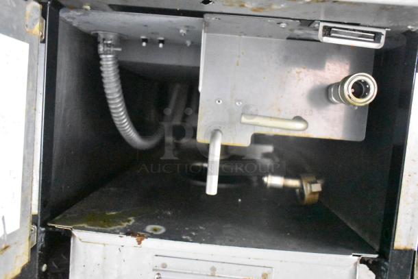 Interior of Cruising Kitchens food trailer showing metal fixtures, wiring, and connections. Condition appears well-maintained.