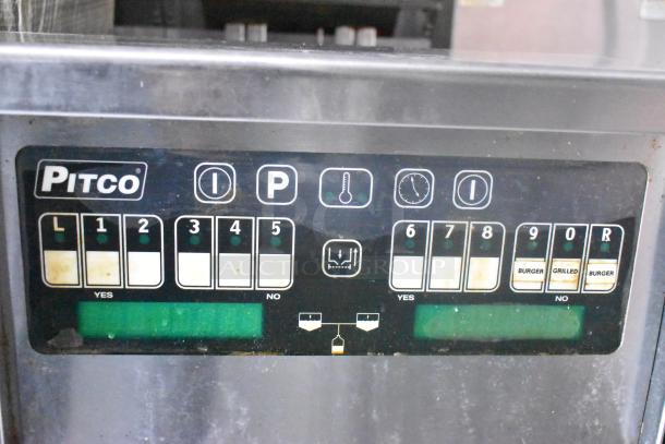 Control panel of a Pitco commercial appliance inside a Cruising Kitchens 24' food trailer, featuring labeled buttons.