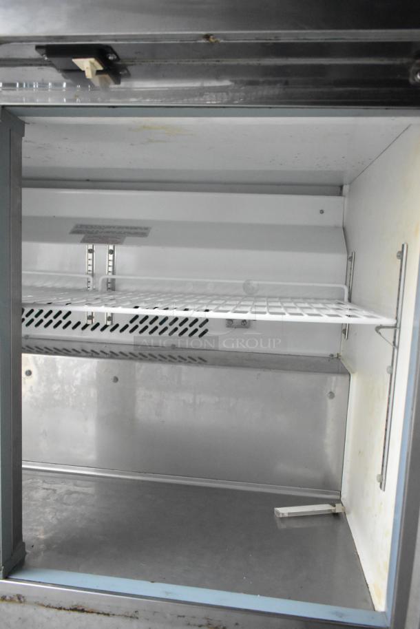 Interior of a 2019 Cruising Kitchens 24' food trailer. Features a clean, spacious commercial-grade refrigerator.