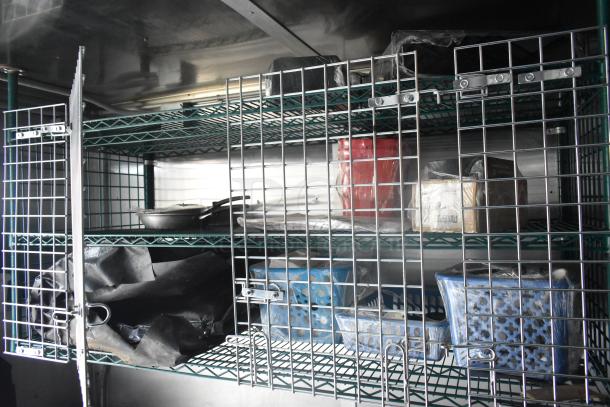 Cruising Kitchens food trailer, interior shelves with commercial kitchen equipment, metal storage, new condition.