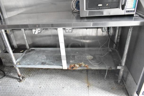 Cruising Kitchens 24' food trailer interior, showing commercial-grade equipment and stainless steel surfaces. Some rust visible.