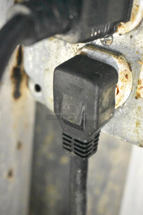 Close-up of electrical plug in Cruising Kitchens food trailer. Features commercial-grade equipment, ready for service.