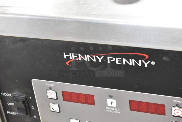 Henny Penny 600 stainless steel natural gas pressure fryer with control panel, 80,000 BTU, on commercial casters, ready condition.