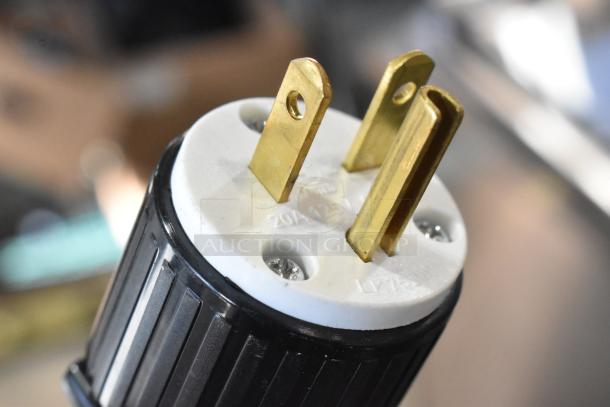 Close-up of the ServIt OAM-138D merchandiser power plug with 20A, 125V specifications visible on the connector.