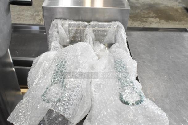 Brand new Avantco 177EF40C stainless steel deep fat fryer with bubble-wrapped metal fry baskets; 208V, 3 Phase.