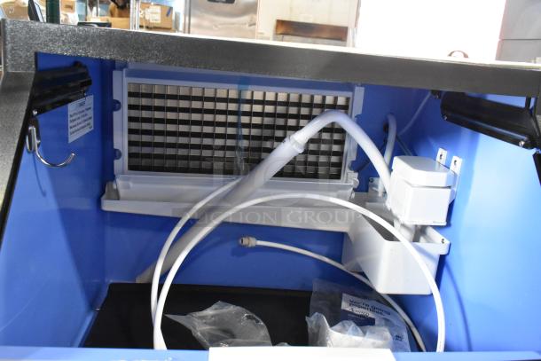 BRAND NEW Avantco 194UCF280A stainless steel undercounter ice machine interior, showing cube grid and internal tubing, 299 lb capacity.