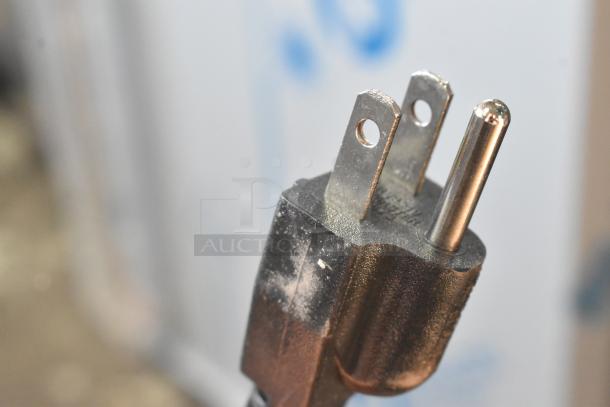 Close-up view of a 3-prong electrical plug for the Bunn 35600.0020 BrewWISE MHG coffee grinder.