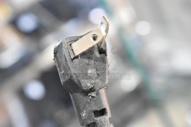 Close-up of a damaged power plug for a 2025 Manitowoc USE0050A-161 ice machine. Plug shows scratches and wear.