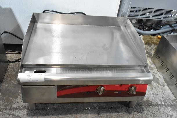 Brand new Avantco 177EG24N stainless steel electric countertop flat top griddle, 208/240V, minor scratches and dents visible.