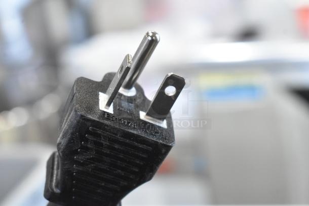 Close-up of a three-prong plug for the Avantco 177EG24N electric griddle. Plug markings visible.