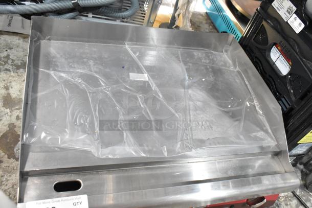 Brand new Avantco 177EG24N stainless steel electric griddle, countertop model. Note visible plastic cover, 208/240V, slight scratches.