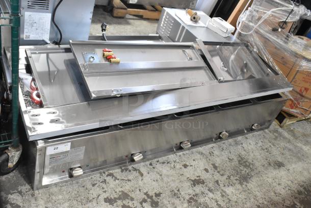 Brand new ServIt 423EST5WSFB stainless steel five-pan sealed well steam table, 240V, with enclosed base, visible minor dents.