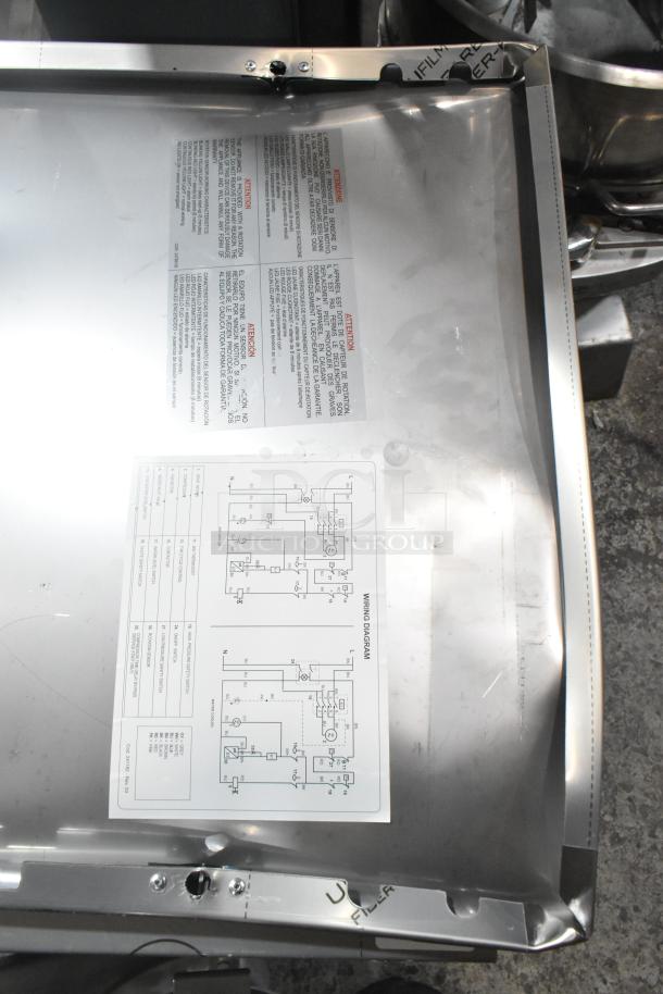 Brand new Manitowoc RFP0620A-161 ice machine, stainless steel, visible dent, wiring diagram; 682 lb. flake ice capacity.