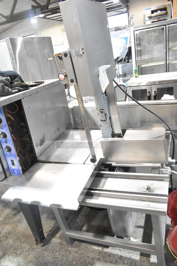 Hobart metal commercial floor-style meat saw, stainless steel, industrial-grade, visible controls, and safety features.