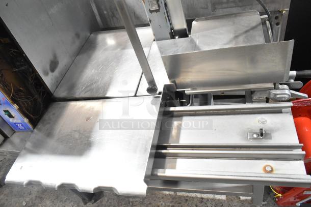 Hobart metal commercial floor-style meat saw with stainless steel table, showing moderate wear, wires visible on control panel.