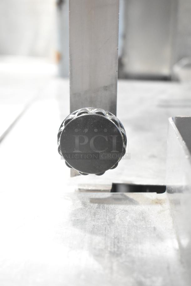 Hobart metal commercial floor style meat saw, features sturdy metal construction and adjustable settings, in good condition.