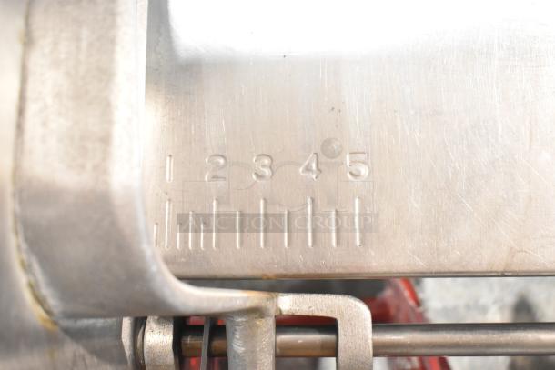 Hobart metal commercial floor meat saw detail, showing measurement markings 1-5 on stainless steel surface.