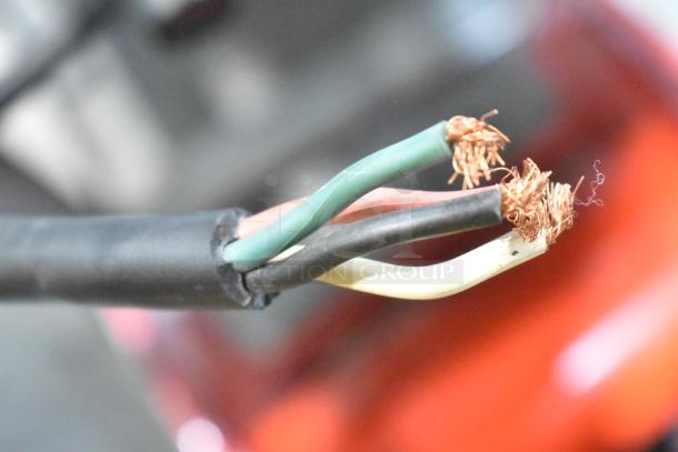Frayed wires on the Hobart metal commercial floor style meat saw, indicating electrical damage and need for repair.