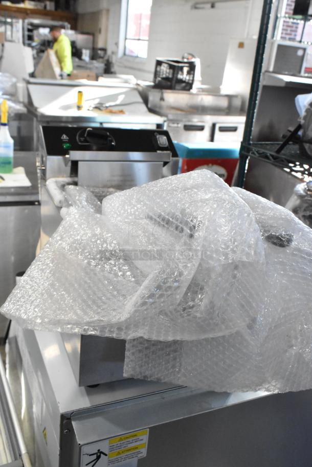 BRAND NEW 2025 Vollrath CF2-1800 stainless steel commercial deep fryer, 10 lb. capacity, two metal baskets, partially wrapped in bubble wrap.