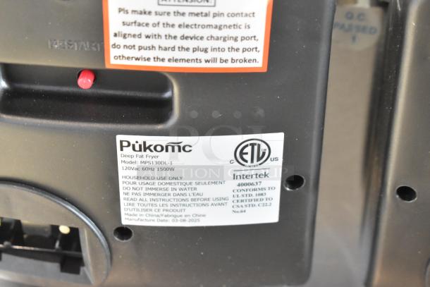 Brand new Pukomc MPS130DL-1 metal countertop 2 bay deep fat fryer, 120 volts, 1 phase, with labels indicating model and specs.