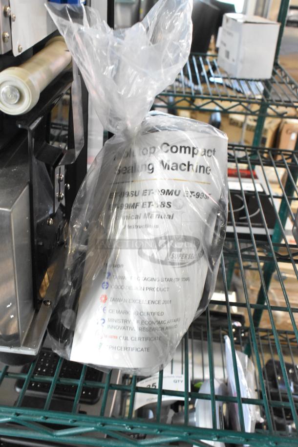 Brand new Bossen ET-99SU metal countertop cup sealing machine, visible in packaging. 110/120V, 1 Phase. Scratch and dent condition.