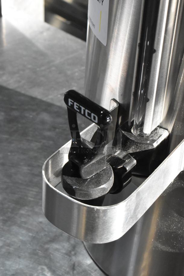 BRAND NEW Fetco TPD-30 Luxus 3 Gallon Stainless Steel Coffee Dispenser, scratch and dent condition, logo visible.