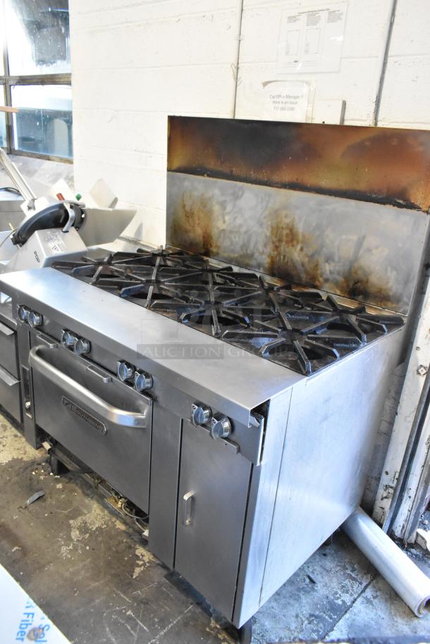 Southbend stainless steel 8-burner range with oven on commercial casters. Used condition with visible signs of operation.