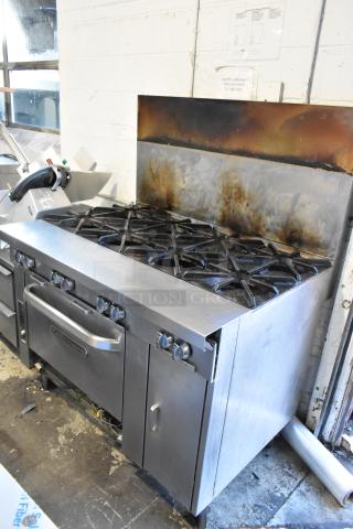 Southbend stainless steel 8-burner range with oven on commercial casters. Used condition with visible signs of operation.